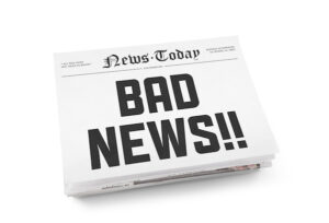 A stack of newspapers with headline "Bad news" on a front page. Isolated on white.